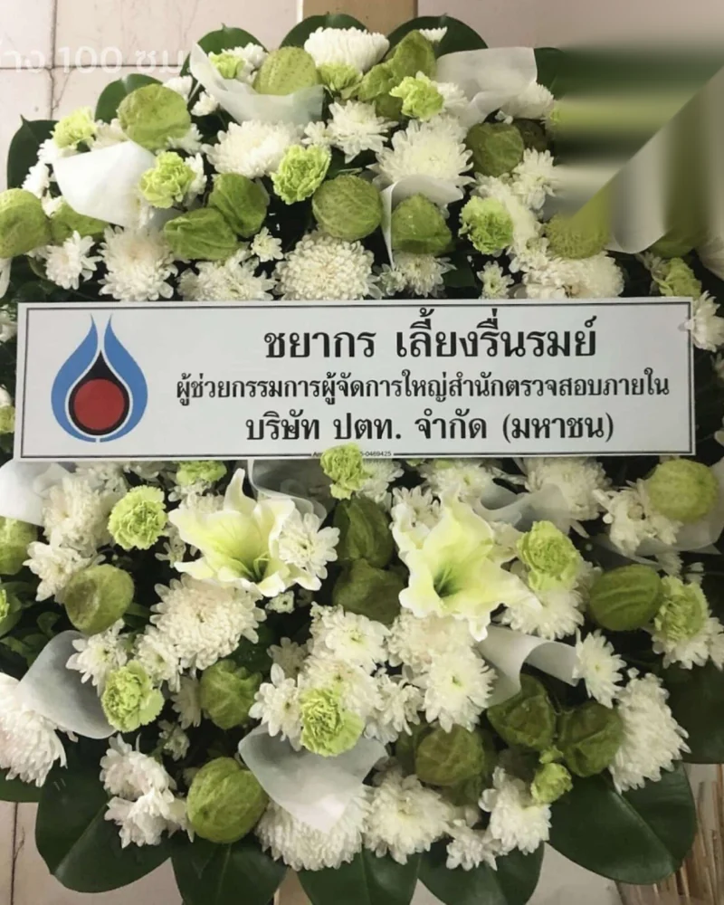 พวงหรีดดอกไม้สดโทนขาวเขียวพร้อมป้ายชื่อผู้ส่งตั้งบนขาตั้ง